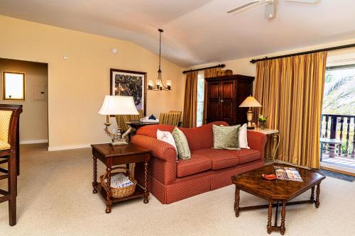 a living room with a red couch and a table at 1 BR Top Floor - private balcony & views 5304 in Saint Augustine