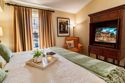 a bedroom with a large bed with a tv on it at 1 BR Top Floor - private balcony & views 5304 in Saint Augustine