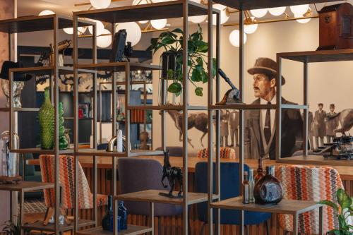a room with shelves with a man in a hat at Hotel Indigo London Clerkenwell by IHG in London