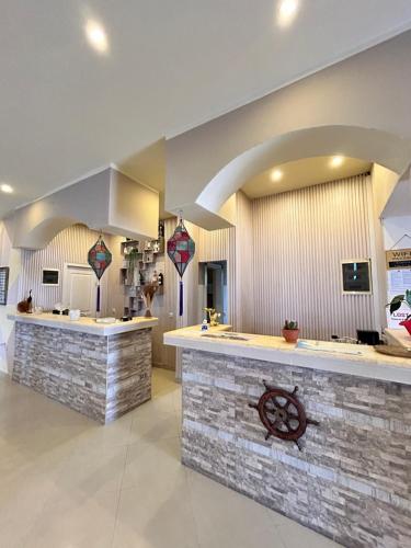 a large kitchen with a stone counter and a kitchen island at Guesthouse Liamra in Ulcinj