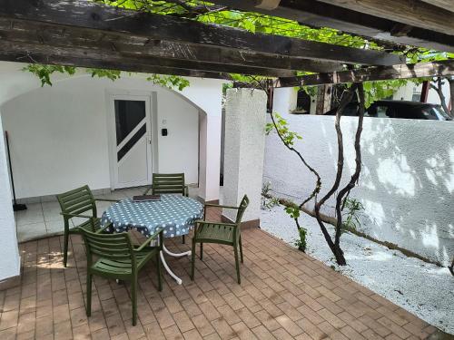 a table and chairs sitting on a patio at Villa 2 Swans in Peroj