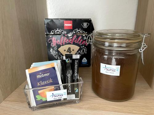 a jar of honey and other items on a table at Hana Aparthotel in Hamburg