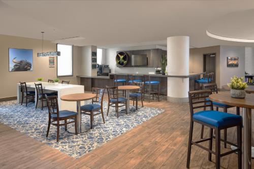 a dining room and kitchen with tables and chairs at The Lodge at Duke Medical Center in Durham