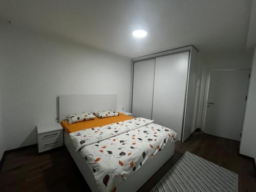 a bedroom with a large bed with orange sheets and pillows at Bazaar Luxury Apartment in Skopje in Skopje
