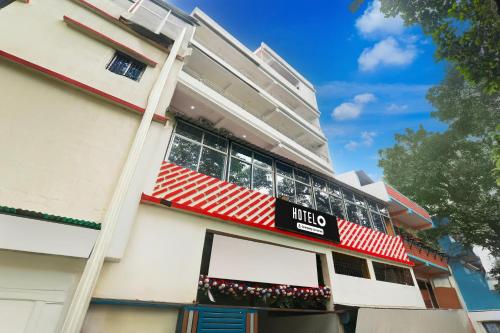 a building with a sign on the side of it at Super Hotel O Kadam Ghat Near Ashok RajPath in Patna