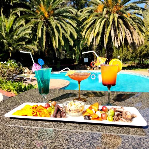 a tray of food on a table next to a pool at Shumba Valley Lodge Lanseria Airport in Lanseria