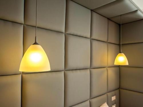 two lights hanging from a wall at VIP apartments 21 in Lviv