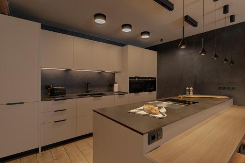 a kitchen with white cabinets and a counter top at Luxury Ski Chalet Andorra in Soldeu
