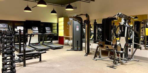 a gym with several tread machines in a room at DoubleTree by Hilton Caracol in Canela