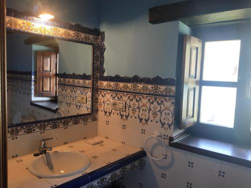 a bathroom with a sink and a mirror at Ribera del Sella III in Dego