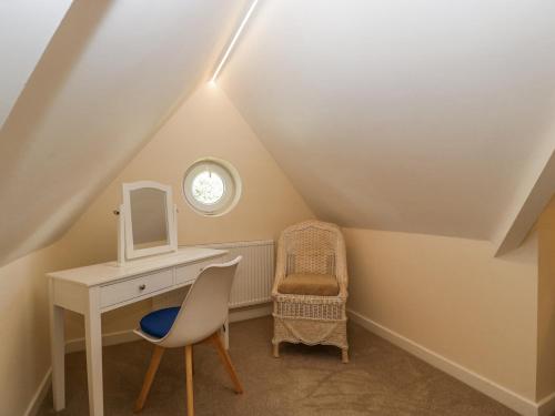 a bathroom with a vanity and a chair in a attic at Bell Garden in Stow on the Wold