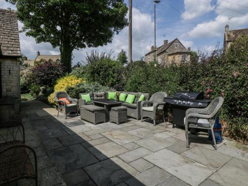 a patio with a bunch of chairs and a table at Bell Garden in Stow on the Wold