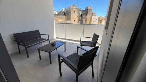 three chairs and a table on a balcony with a view at Valesium Home in Lecce