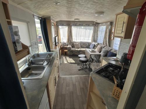 a kitchen and living room of an rv at Holiday Caravan in Clacton-on-Sea