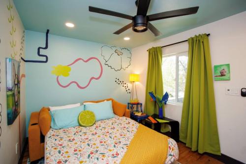 a bedroom with a bed and a ceiling fan at Charming NEW Retreat, Prime Location Mins to DT & PHX Airport in Phoenix