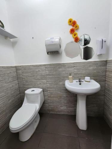 a bathroom with a toilet and a sink at Mochila Urban1 in San Salvador