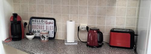 a kitchen counter with various appliances on a counter top at Maison à 50 M de la plage sous les pins in Saint-Brevin-les-Pins