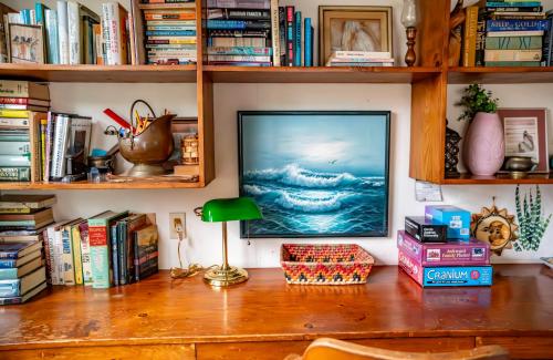a television sitting on a desk with books at Bohemian Bungalow in Port Saint Lucie
