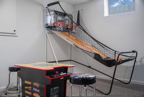 a room with a batting cage and a net at Central Family Oasis with Hot Tub & Fenced Yard in Omaha