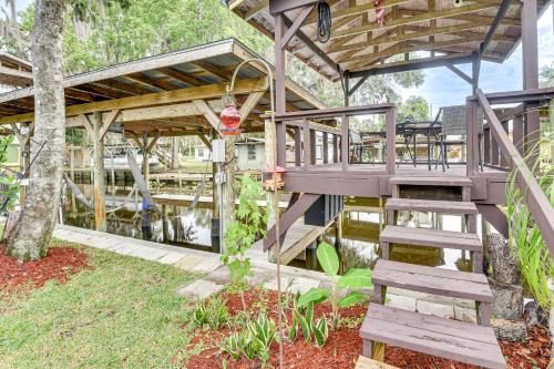 a wooden staircase leading to a deck in a garden at Boat Dock and Waterfront Deck Home in Satsuma! in Satsuma