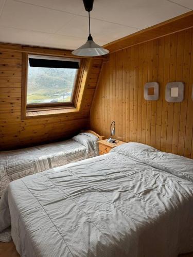 a bedroom with a large bed and a window at BIG Grandalla by CONFORTSKY in Pas de la Casa