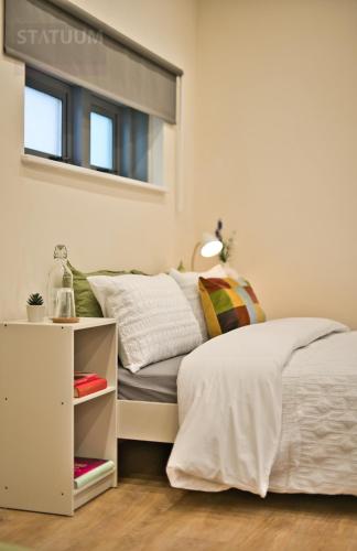 a small bedroom with a bed and a window at Stratford, London E15 - modern Studio for 3 in London