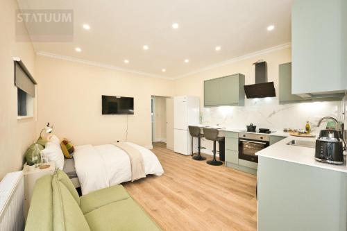 a kitchen and a living room with a bed in a room at Stratford, London E15 - modern Studio for 3 in London