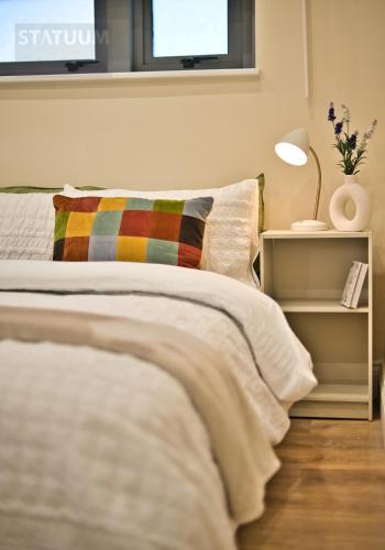 a bedroom with a bed with a pillow and a window at Stratford, London E15 - modern Studio for 3 in London