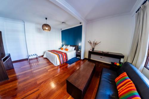 a hotel room with a bed and a couch at La Casona Hotel Boutique in La Paz