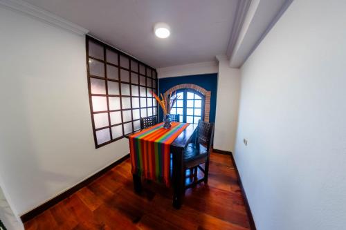 a room with a table in a room with a window at La Casona Hotel Boutique in La Paz