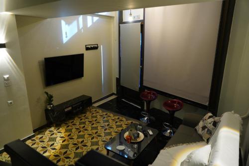 a living room with a couch and a flat screen tv at Karditsa's Loft House in Kardítsa