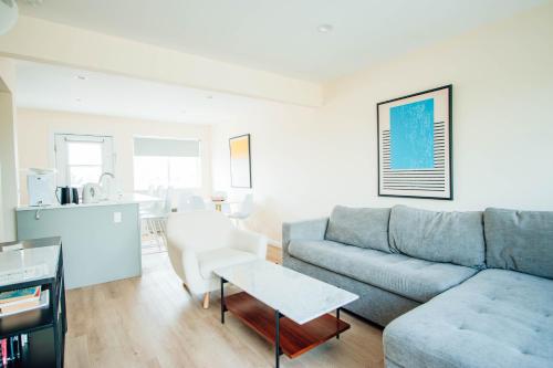 a living room with a couch and a table at Sea Crest in Amagansett