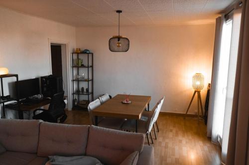 un salon avec un canapé et une table dans l'établissement Cozy & bright apartment, à La Celle-sous-Gouzon