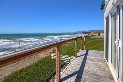 a balcony with a view of the ocean at Oceanfront Escape in San Simeon