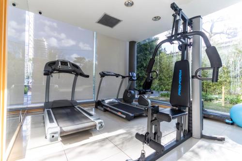 a gym with two treadmills and two ellipticals at Park Hotel in Punta del Este