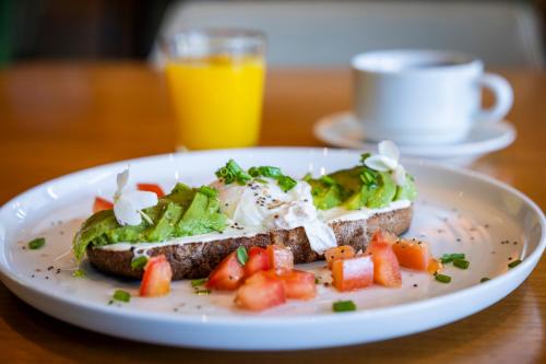 a plate of food with a sandwich on a table at Park Hotel in Punta del Este