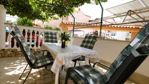a table and chairs sitting on a balcony at Apartment Zdravko in Štinjan