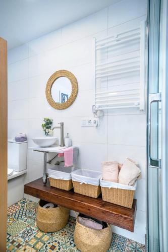 a bathroom with a sink and a counter with baskets at Cova dos Frei in Vigo