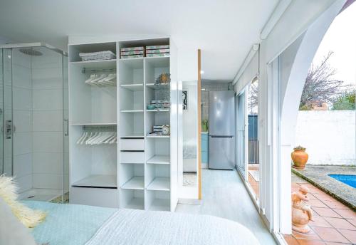a bedroom with a walk in closet and a shower at Cova dos Frei in Vigo