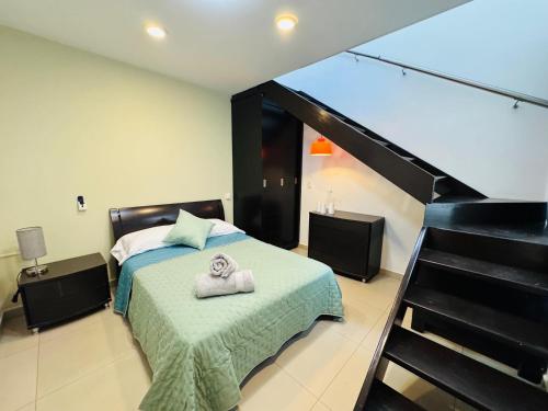 a bedroom with a bed with two towels on it at Casa Jacaranda Business Lodge 7 Suites Cowork Terrace in Irapuato