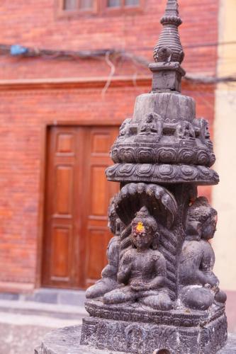 a statue of two children on a fountain at Mandhah Heritage Home in Kathmandu