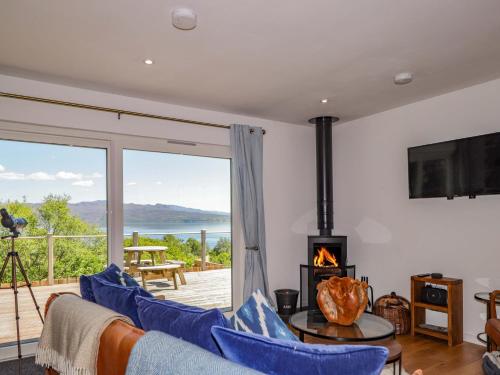 a living room with a couch and a fireplace at The Lookout in Saasaig