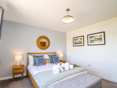 a bedroom with a bed and a mirror on the wall at The Lookout in Saasaig