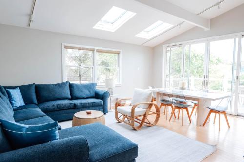 a living room with a blue couch and a table at Driftwood Resort on the Ocean in Montauk