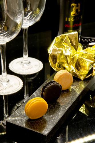 a table with two glasses of wine and some chocolates at Hugo's Boutique Hotel - Adults Only in St Julian's