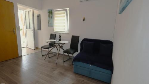 a room with a bed and a table and chairs at Apartment Zdravko in Štinjan