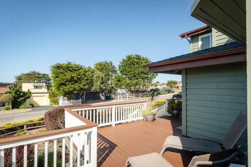 a balcony of a house with a wooden deck at Casa De La Mar in Cambria