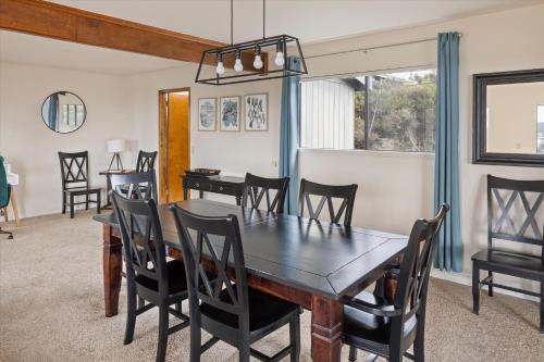 a dining room with a table and chairs at Cambridge View in Cambria