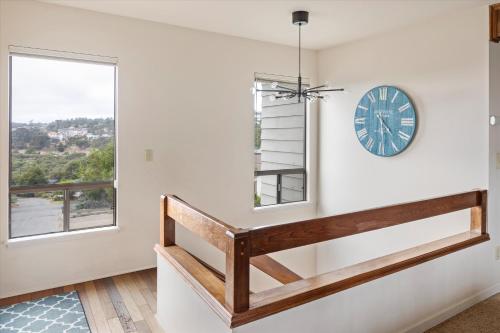 a clock on a wall next to a window at Cambridge View in Cambria