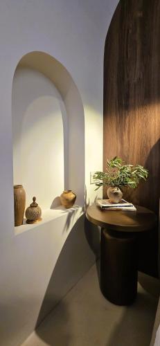 a room with vases and a table with a plant on it at C a s a B e a s t in Split